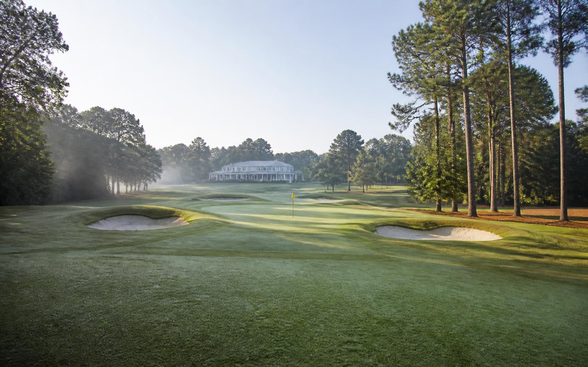 A tree-lined green space near a Charlotte country club