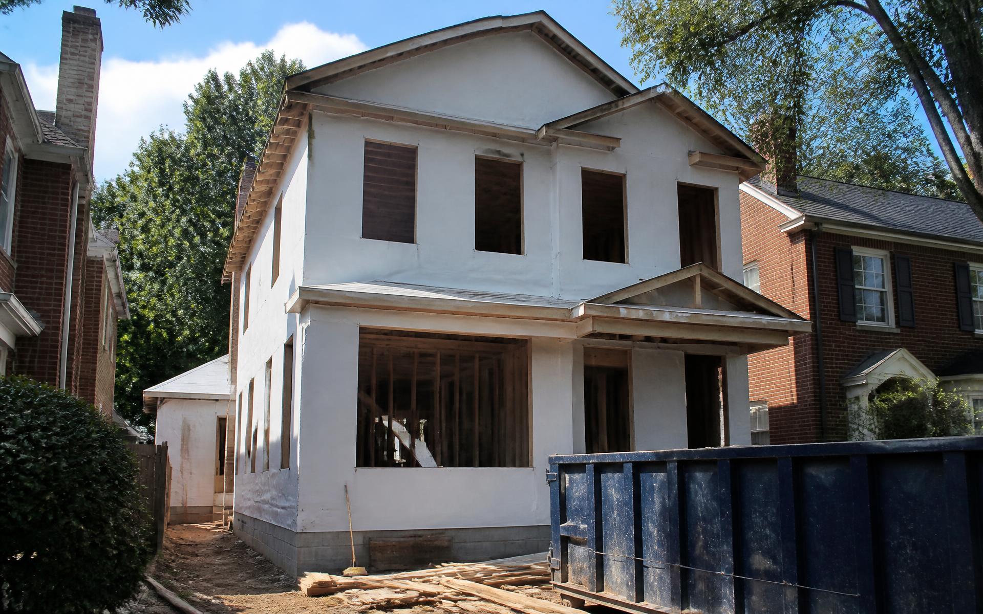 A new custom home under construction on an established Cotswold street